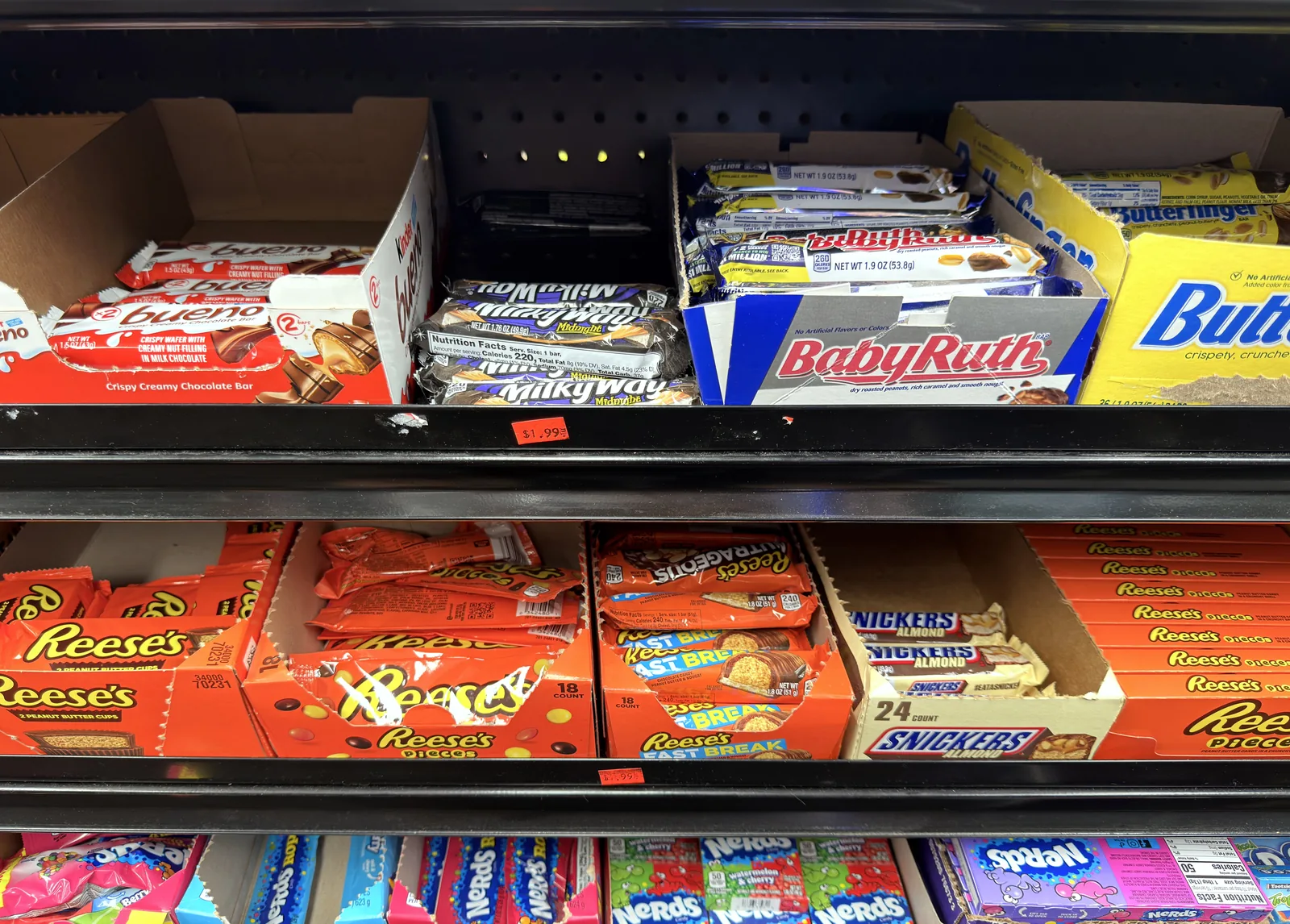 A candy shelf with no price labels